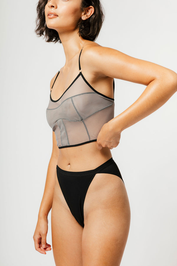 model wearing black bikini cut panty and grey mesh longline bra