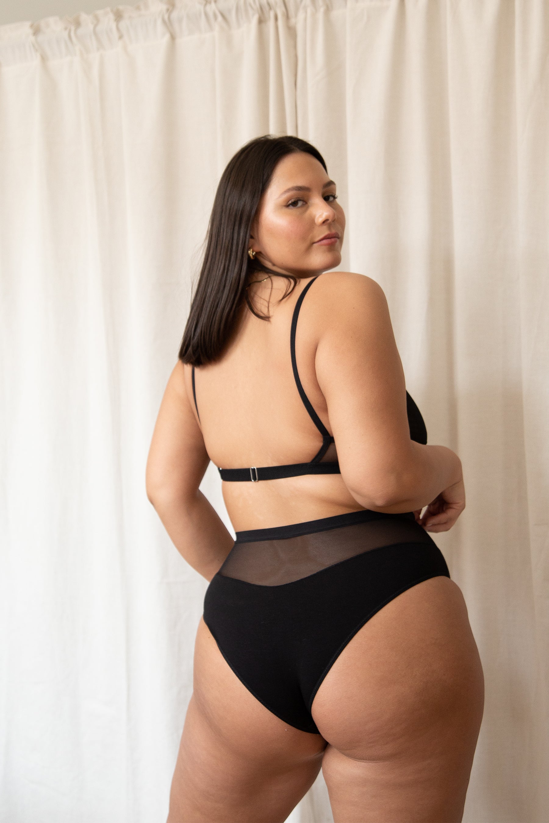 model posing in black high waist mesh and bamboo rayon bikini panty