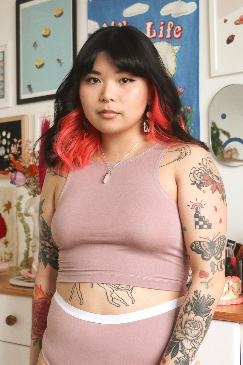 Woman with nose piercing and tattoos wearing a bamboo cropped tank top